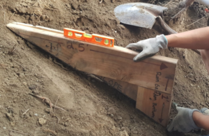 An example of a triangular wooden jig with a level mounted on it. 